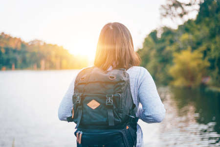 The Young woman with backpack standing by the lake, Travel, Freedom, Lifestyle conceptの写真素材