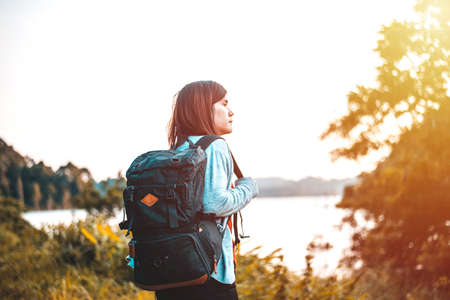 The Young woman with backpack standing by the lake, Travel, Freedom, Lifestyle conceptの写真素材