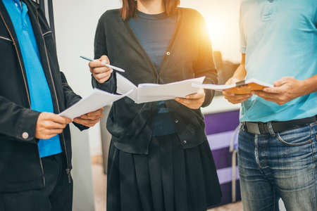 Co-workers men and woman in office talk about project.の写真素材