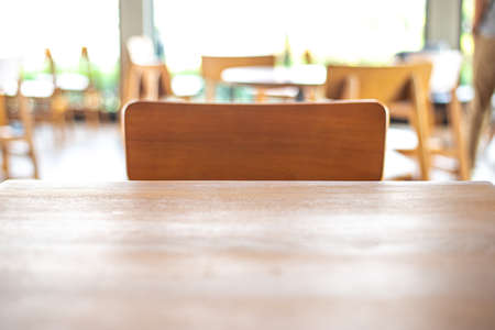 Empty wood table top on blurred background form coffee shopの写真素材