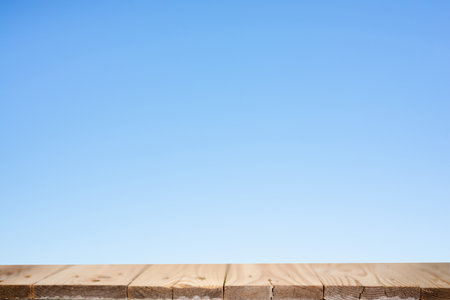 Wood plank table top on blue backgroundの写真素材