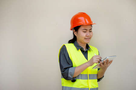 Engineer woman wearing uniform and safety helmet inspection workの写真素材