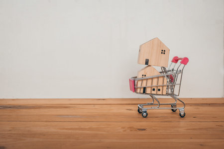 Home in Shopping cart , Buying and selling real estate, Home conceptの写真素材