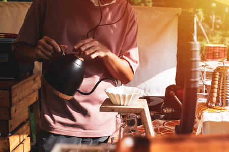 Barista dripping hot coffee into the cup with equipmentの写真素材