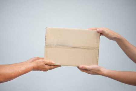 Courier giving parcels to customer, Receiving packageの写真素材