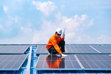 Engineer service check installation solar cell on the roof of factory , Sustainable energy industry...