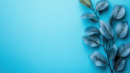 A blue background with a leafy green plant on it. The plant is surrounded by water droplets, giving it a fresh and lively appearanceの素材