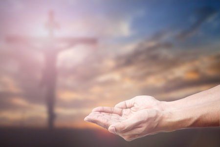 Praying Hand and the cross blurred background.の写真素材