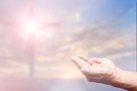 Praying Hand and the cross blurred background.の写真素材