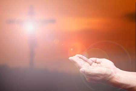Praying Hand and the cross blurred background.の写真素材