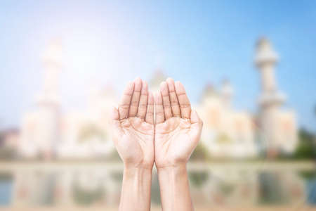 Human hands pray and mosque background.の写真素材
