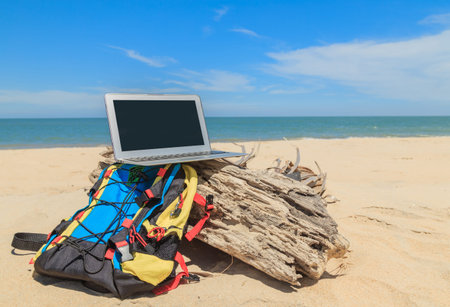 Notebook put on wood and sand for man or woman coming to working.の写真素材