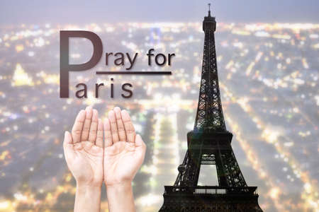 Empty female open human hands prayer with abstract Background top view of Paris in lights and bokeh. Concept for pray for Paris, Thanksgiving, Christmas, Forgiveness.の写真素材