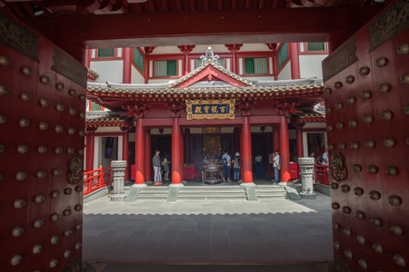 SINGAPORE - 27 MAR, 2014 :People Praying to Statue of Buddha Red Chinese temple, Buddha Tooth Relic Temple and Museum in Chinatown in Singaporeのeditorial素材