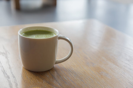 Closeup one  cup of hot Green Tea on clean wooden table in morning light. space for text design. Aroma love caffeine smell.の写真素材
