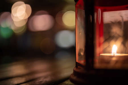 Abstract candle lantern light on wood table in blur bokeh pub restaurant dinner background concept for ramadan kareem night life, wooden tabletop dark indoor counter, happy kid mubarak.の写真素材