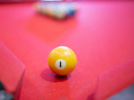 Billiard ball on red table background in pub bar room concept for sport gamble activity, game play competition.の写真素材