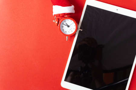 Creative flat lay vintage clock on red office table top view background concept alarm clock on red paper color with copy space in minimal style, empty template for text, break workplace at noon for lunch, back to school.の写真素材