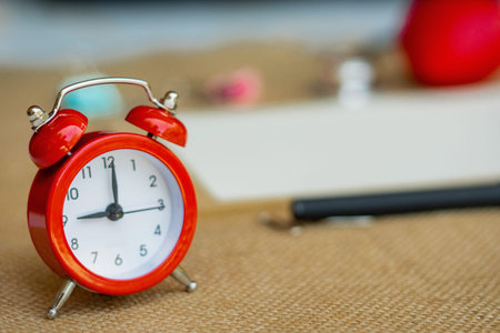 Creative flat lay vintage clock on red office table top view background concept alarm clock on red...