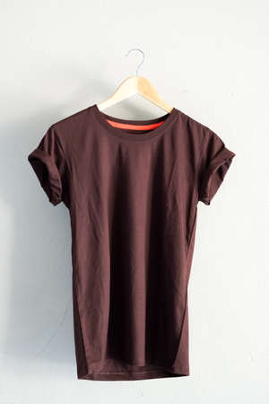 Retro fold Yellow brown cotton T-Shirt clothes colorful mock up template on grunge white wood background concept for retail dress shop backdrop, Blank flat lay vintage grey wooden plain laundry advertisingの写真素材