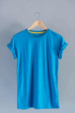 Retro fold blue cotton T-Shirt clothes mock up template on grunge white wood background concept for retail dress shop backdrop, Blank flat lay vintage grey wooden plain laundry advertisingの写真素材