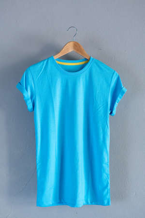 Retro fold blue cotton T-Shirt clothes mock up template on grunge white wood background concept for retail dress shop backdrop, Blank flat lay vintage grey wooden plain laundry advertisingの写真素材