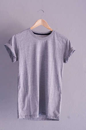 Retro fold grey cotton T-Shirt clothes mock up template on gray cement background concept for retail dress shop backdrop, Blank flat lay vintage grey wall plain laundry advertisingの写真素材