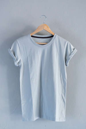 Retro fold blue cotton T-Shirt clothes mock up template on grunge white wood background concept for retail dress shop backdrop, Blank flat lay vintage grey wooden plain laundry advertisingの写真素材