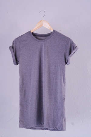 Retro fold purple cotton T-Shirt clothes mock up template on grunge white wood background concept for retail dress shop backdrop, Blank flat lay vintage grey wall plain laundry advertisingの写真素材