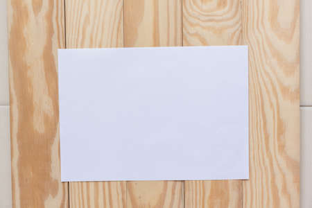 Abstract Blank one white paper on wooden table top view background concept for empty letter business sheet, plain brochure mock up template, flyer card, notebook frame notepad.の写真素材
