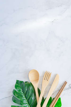 Bamboo wood toothbrush on clean white marble table top view background concept for save the earth day, world environmental, plastic free, kitchen flat lay lifestyle, bathroom reusable wood product.の写真素材