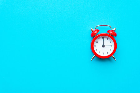 Abstract creative flat lay vintage blue table top view office background concept red clock on paper...