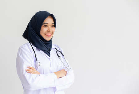 Young Arab Muslim intern doctor women smile on isolate white background concept for Islam people working in medical hospital health care, Modern Nurse wearing hijab in medico clinic business service.の写真素材