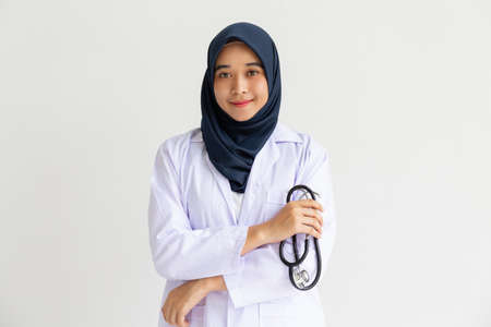 Young Arab Muslim intern doctor women smile on isolate white background concept for Islam people working in medical hospital health care, Modern Nurse wearing hijab in medico clinic business service.の写真素材