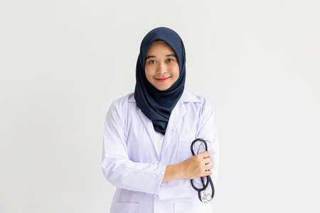 Young Arab Muslim intern doctor women smile on isolate white background concept for Islam people working in medical hospital health care, Modern Nurse wearing hijab in medico clinic business service.の写真素材