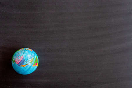 World map on Blank front Real black chalkboard background texture in college concept for back to school kid wallpaper for create white chalk text draw graphic. Empty old back wall education blackboard.の写真素材