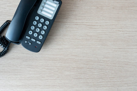 The old black phone on the business office desk in the wood be used for contact Connect, above on...