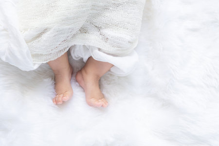 Cute newborn baby girl in white blanket onÂ nurseryÂ bed.Â AdorableÂ new born child, little...