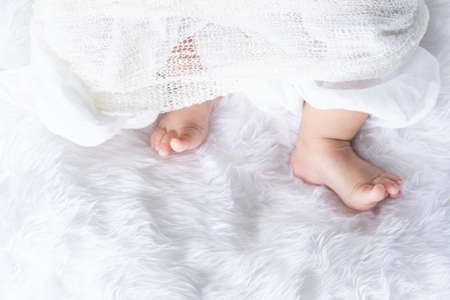 Cute newborn baby girl in white blanket onÂ nurseryÂ bed.Â AdorableÂ new born child, little boy eyes look people Family, new childhood, infant soft skin portrait concept.Â Jaundice syndromeÂ life hospital.の写真素材
