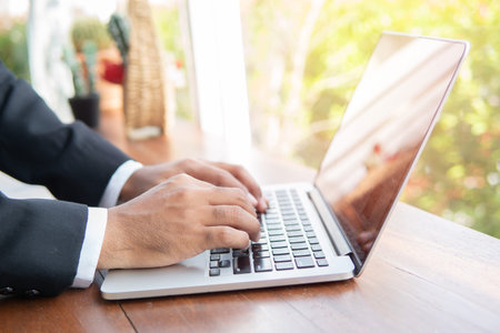 Business man hand hold credit card to shopping internet online bill on computer, Debit saving...