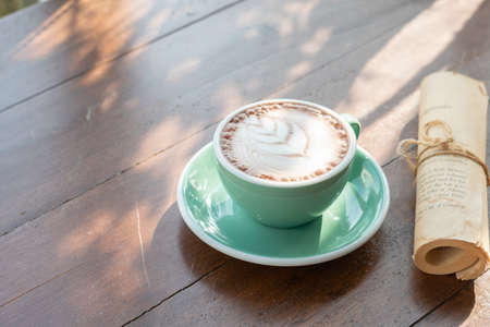 One coffee cup of hot black cappuccino on clean wooden table top view in warm morning light. Hot espresso in ceramics mug on empty rustic brown wood color concept for Aroma love caffeine taste smell.の写真素材