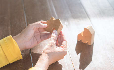 Real estate customer hand choose home models to Decide purchase decisions. Buyer and seller offers a loan to build a house. Family life agent offer products mockup for sales, realtor concept.の写真素材