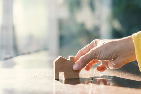 Real estate customer hand choose home models to Decide purchase decisions. Buyer and seller offers a loan to build a house. Family life agent offer products mockup for sales, realtor concept.の写真素材