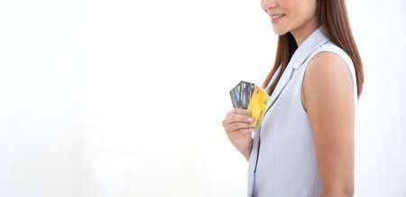 Happy woman smile at credit card, hold shopping reward bonus on panoramic isolate white background. Wide Student customer people show debit reward for discount payment, loan dept purchase conceptの写真素材