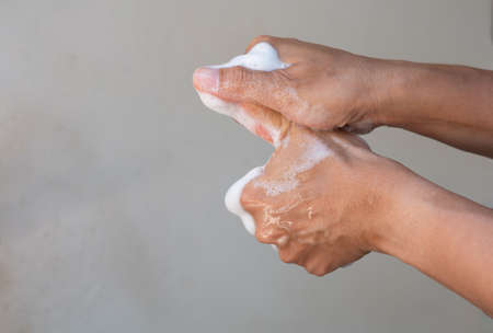 Muslim women wash hand with soap alcohol gel for sanitizer in kitchen sink concept for prevent Hygiene health care. Quarantine Islam people spread of germs and microbe bacteria outbreak coronavirus 19の写真素材