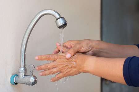 Muslim women wash hand with soap alcohol gel for sanitizer in kitchen sink concept for prevent Hygiene health care. Quarantine Islam people spread of germs and microbe bacteria outbreak coronavirus 19の写真素材
