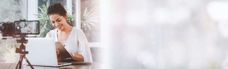 Young student woman use wireless internet learning and co-working at home on mobile tablet app. Modern girl people blogger couch on laptop education classroom online device, Social distancing in spaceの写真素材