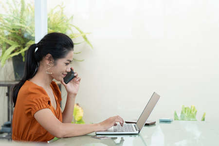 Young student woman use wireless internet learning and co-working at home on mobile tablet app. Modern girl people blogger couch on laptop education classroom online device, Social distancing in spaceの写真素材