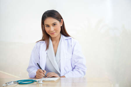 Young intern doctor women smile on isolate whiteの写真素材