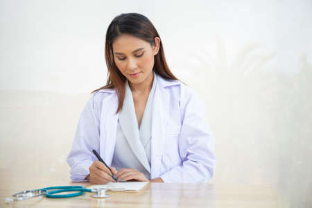 Young intern doctor women smile on isolate whiteの写真素材